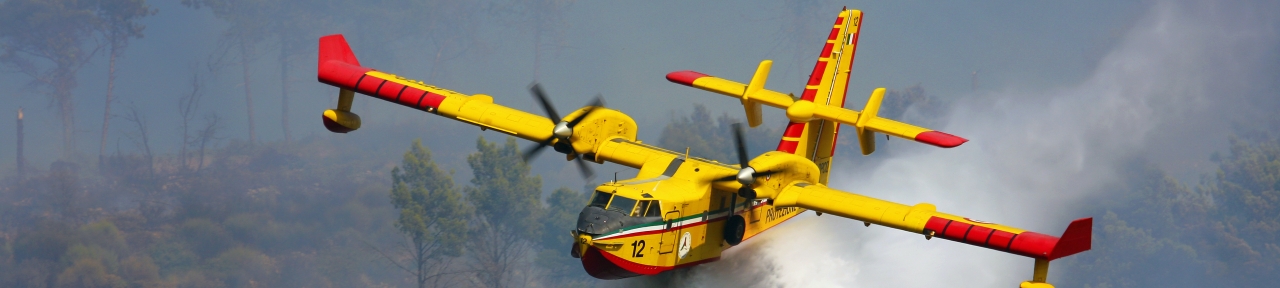 CL-415 water bomber dropping water on forest fire