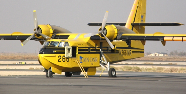 Yellow and black CL-215 aircraft on the runway